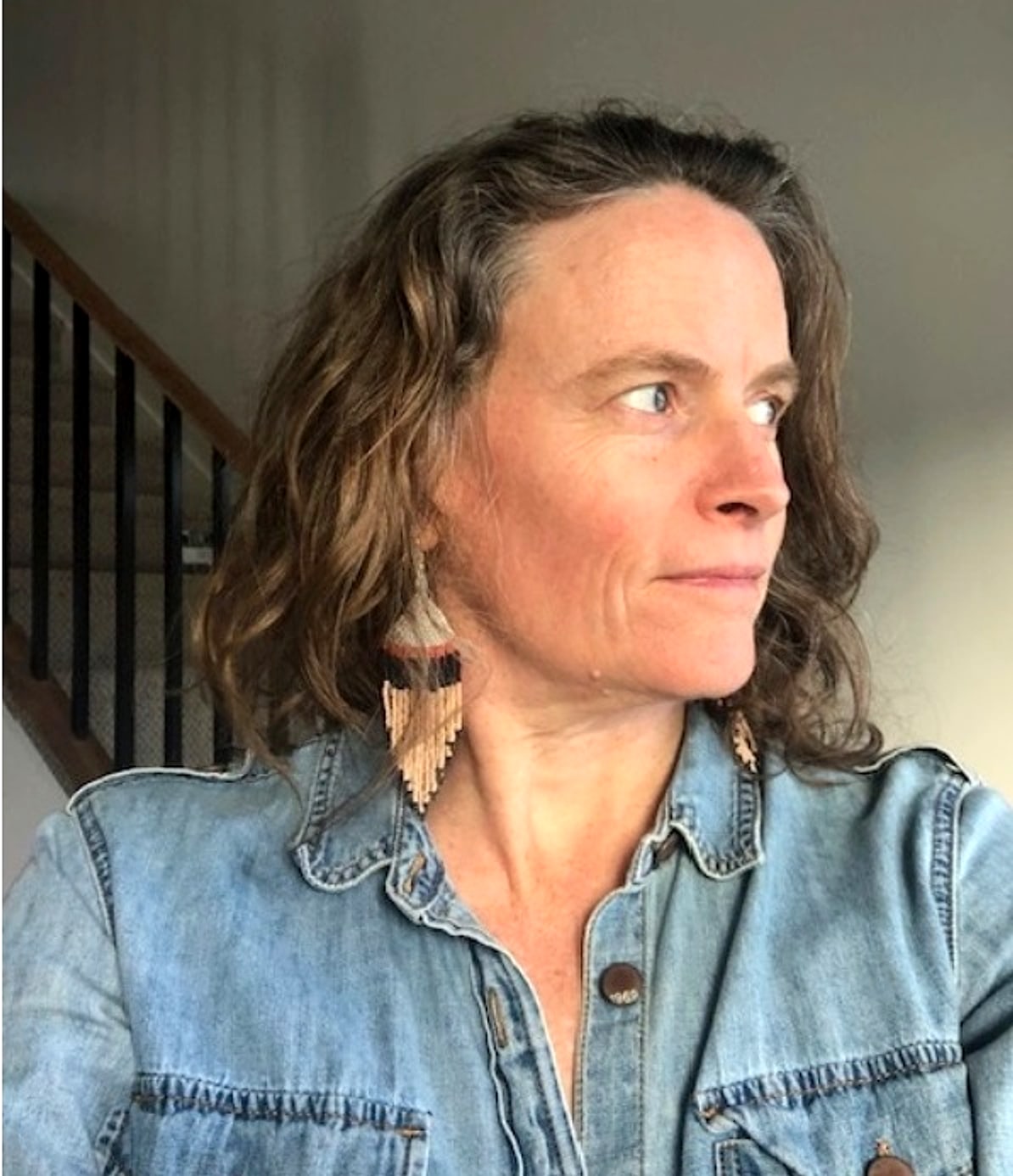 Anna Switzer, smiling softly and looking off to one side